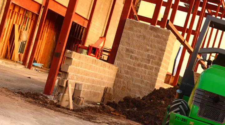 Blockwork walls rising from a new foundation on a building site